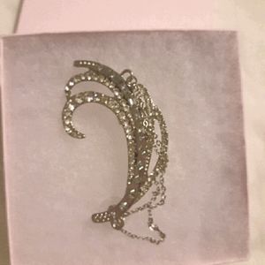 Silver toned crystal earring with clip at the top